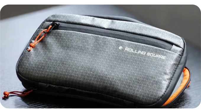 The Tech Pouch in grey ripstop with orange accents